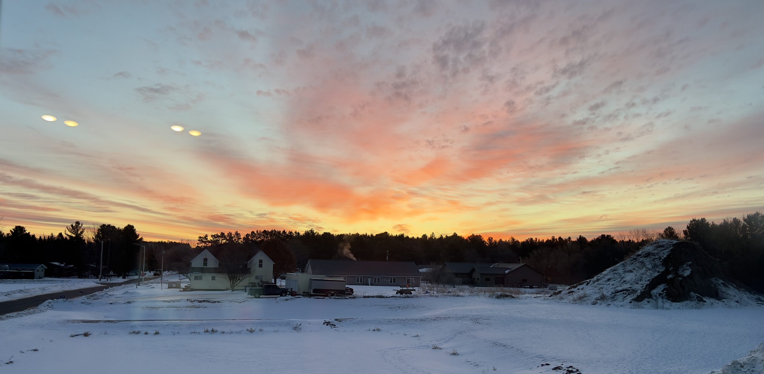 Sunrise over land covered in snow